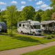 Lush RV park with joyful travelers